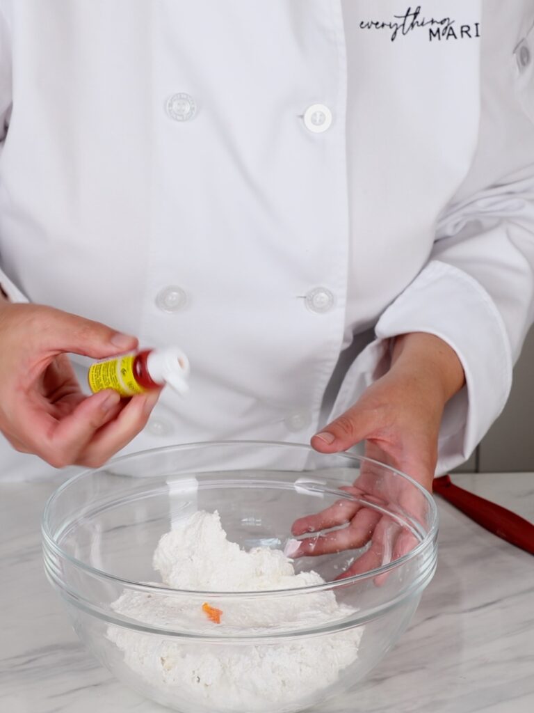 Adding food color to macaronage. 