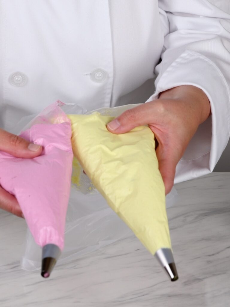 Yellow and pink macaronage in the pastry bags. 