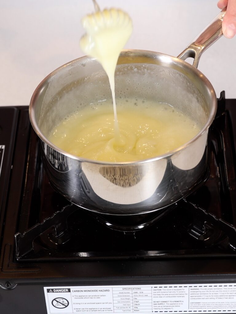 Cream in the saucepan with the whisk. 