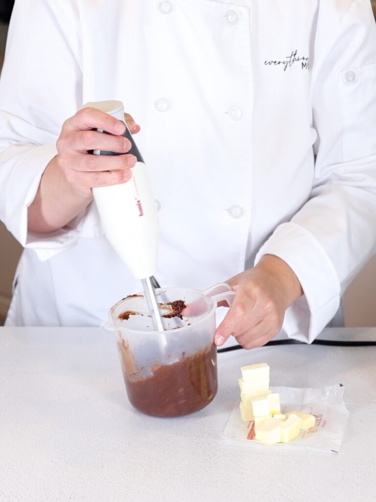 Emulsifying ganache with an immersion blender. 