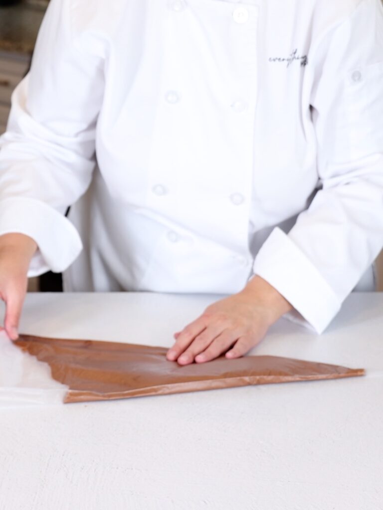 Ganache in the pastry bag on the table. 