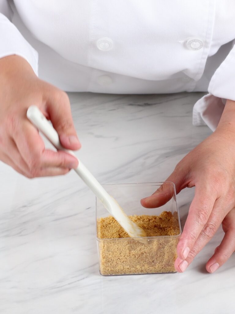 Leveling crumbs with the spatula.