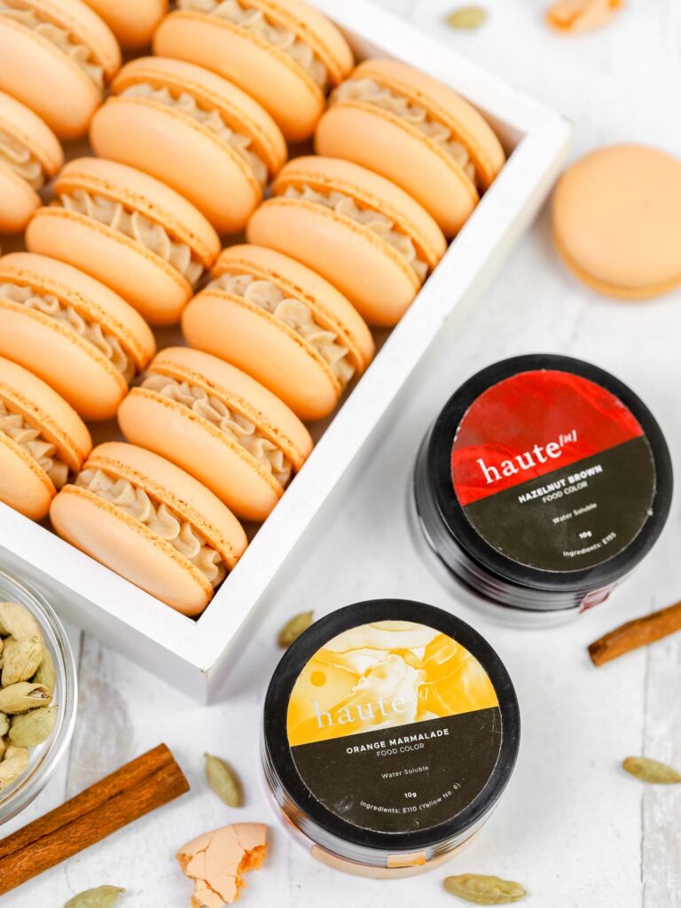 Cinnamon Cardamom Macarons in the white box with food coloring.