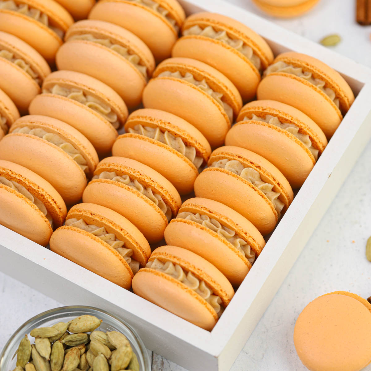 Orange macarons in the white box.
