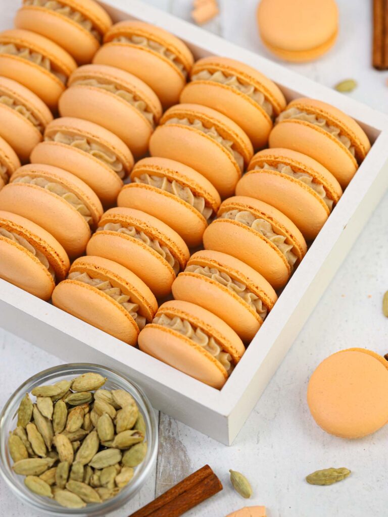 Orange macarons in the white box.