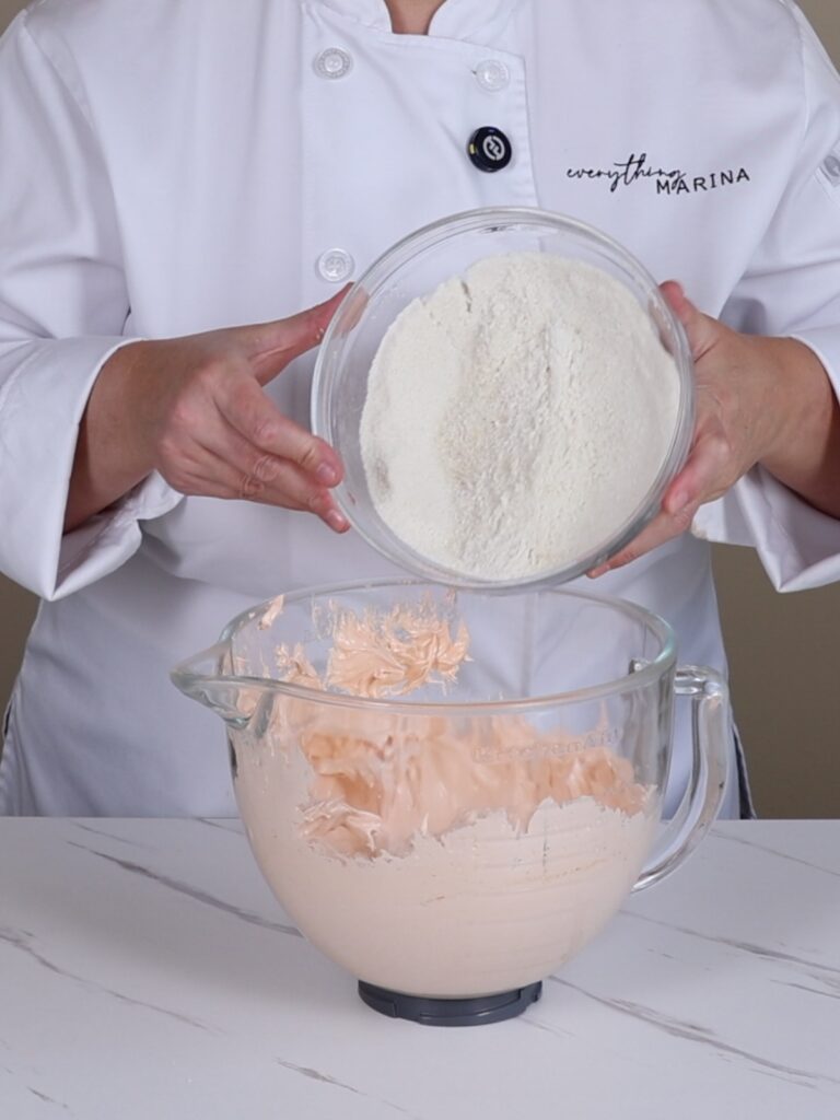 Adding dry ingredients to the French meringue.