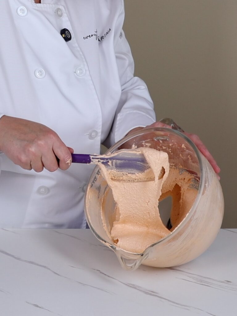 Orange macaronage in the mixing bowl.