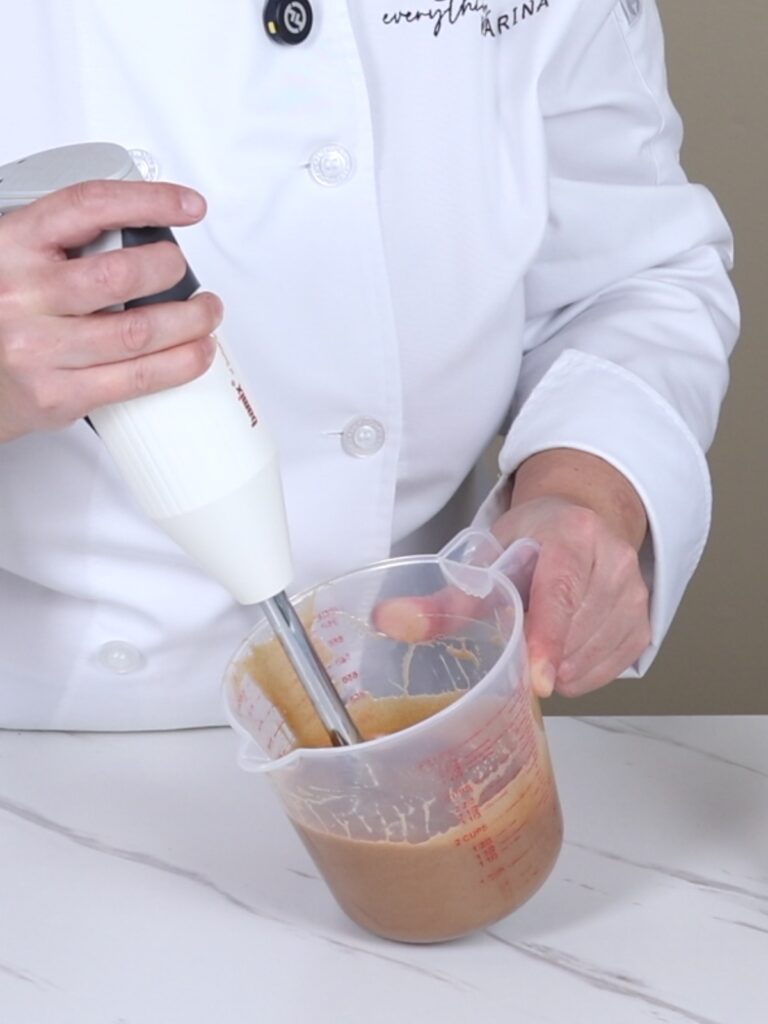 Emulsifying ganache with an immersion blender.