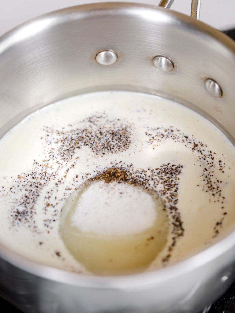 Saucepan with heavy cream, sugar, and spices.