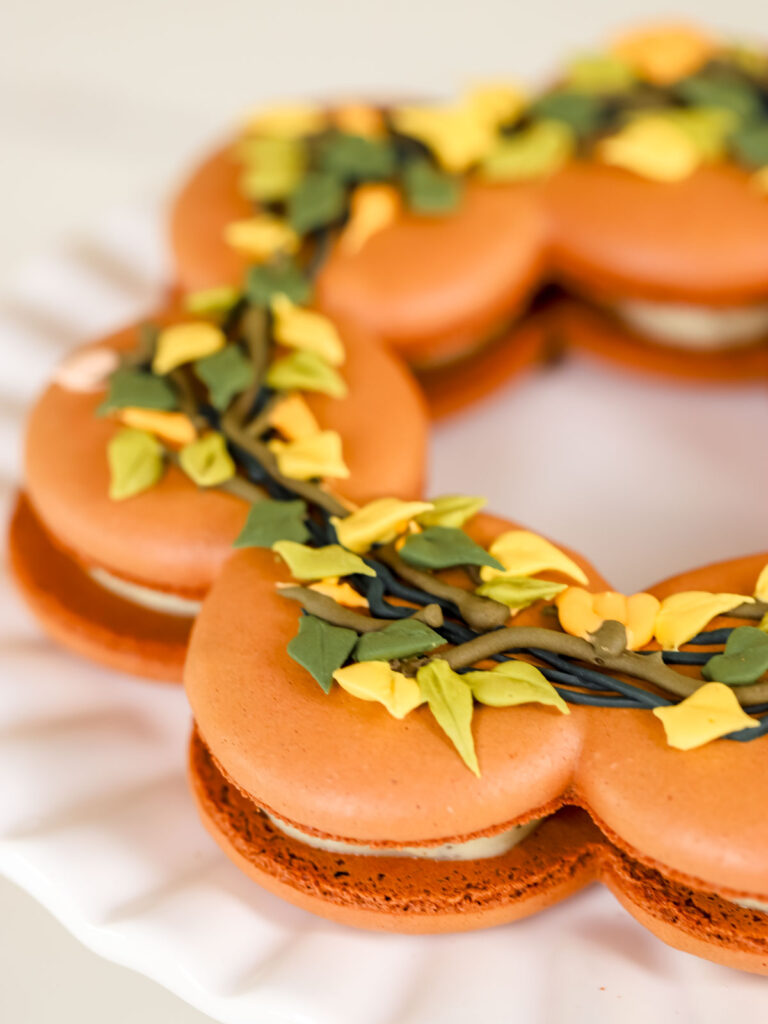 Brown macarons in the shape of a wreath.