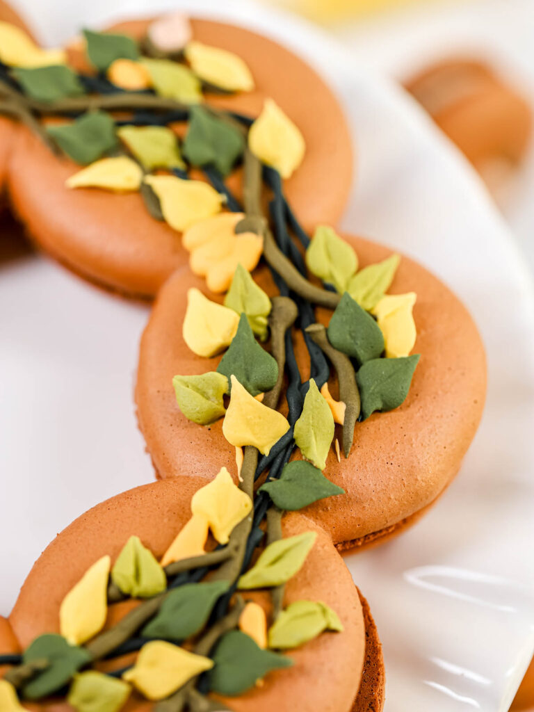 Brown macaron wreath decorated with royal icing.