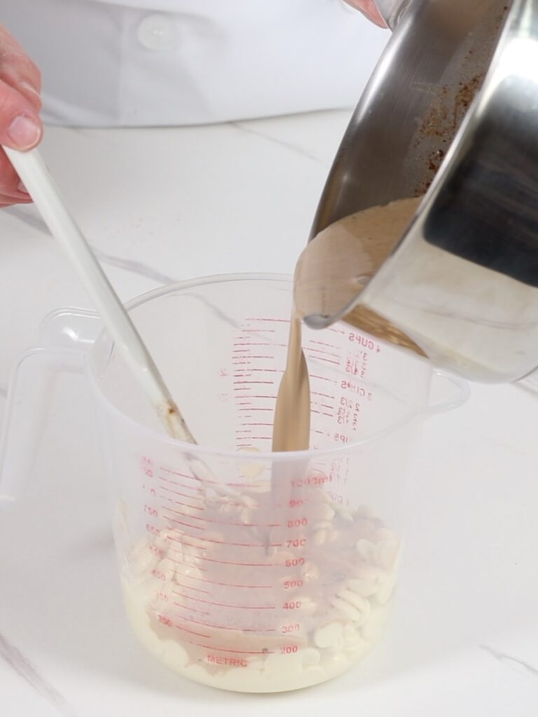 Pouring heavy cream to cup. 