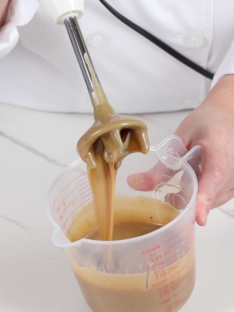 Immersion blender in the cup with the ganache. 