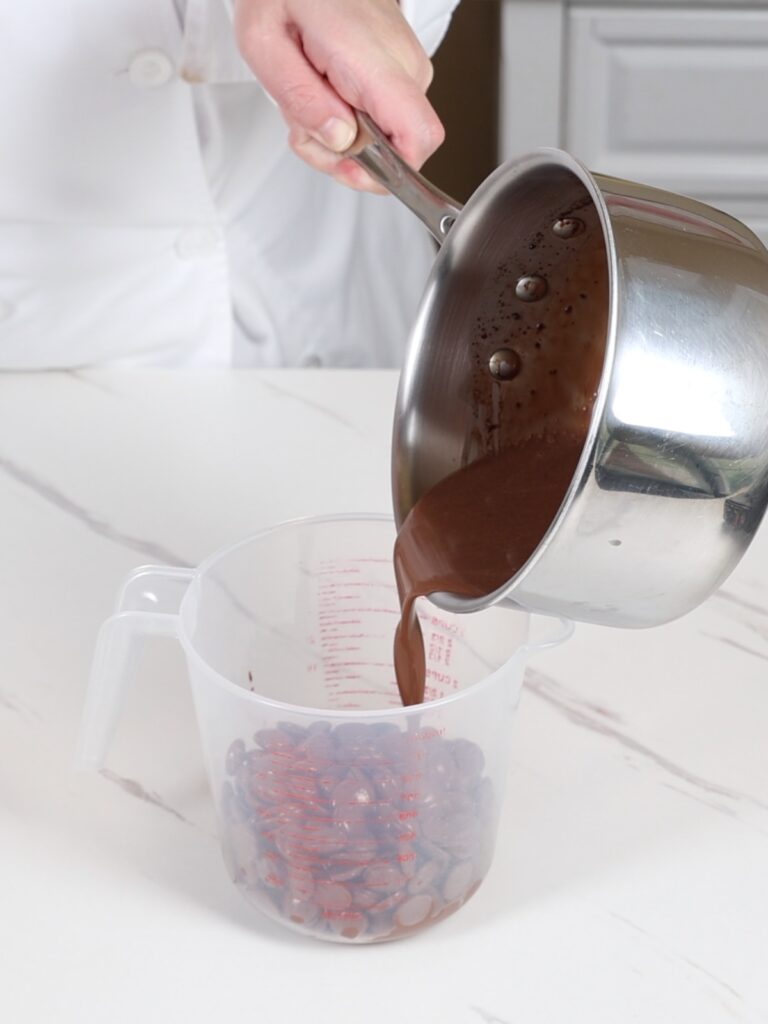 Pouring the hot mixture into the chocolate. 