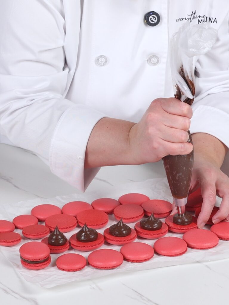 Pipe peppermint mocha ganache on the macaron shell. 