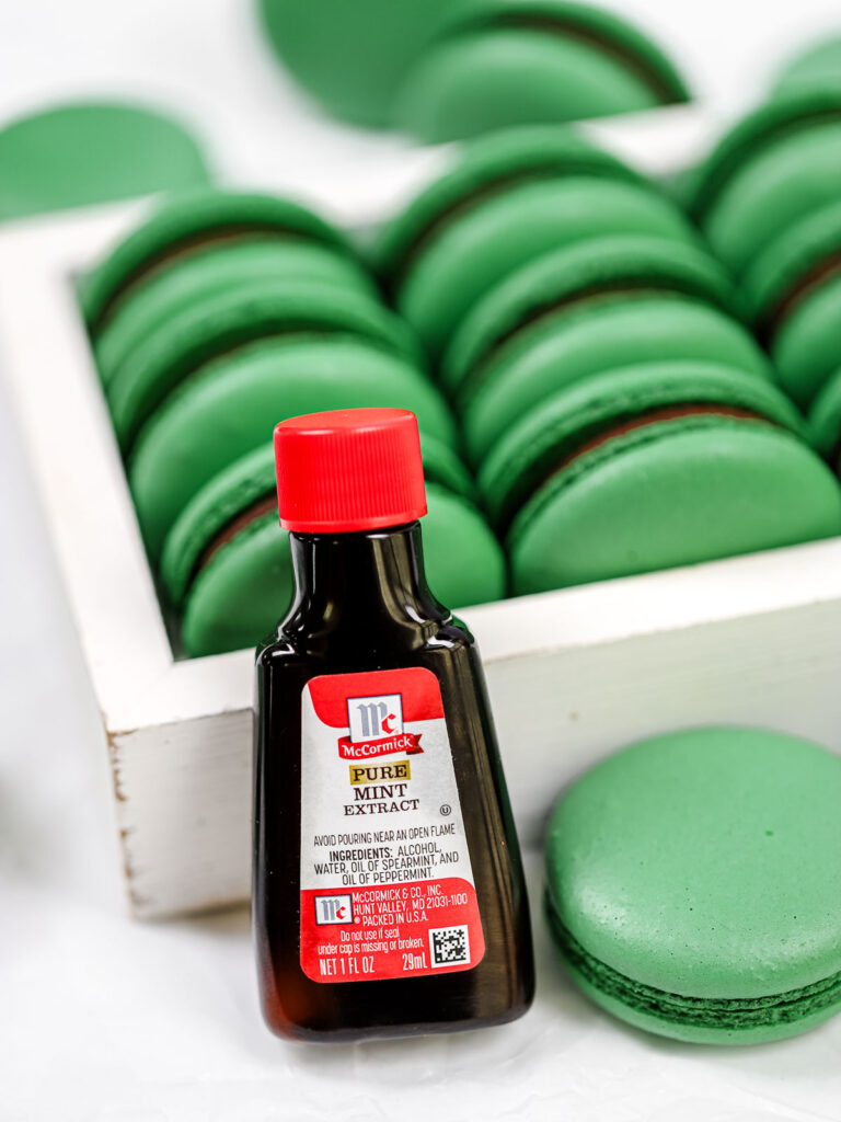 Mint extract bottle with green macarons. 