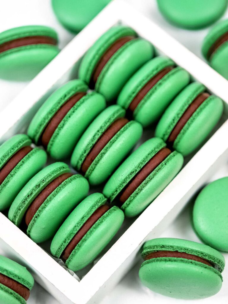 Mint Chocolate Macarons in the box. 
