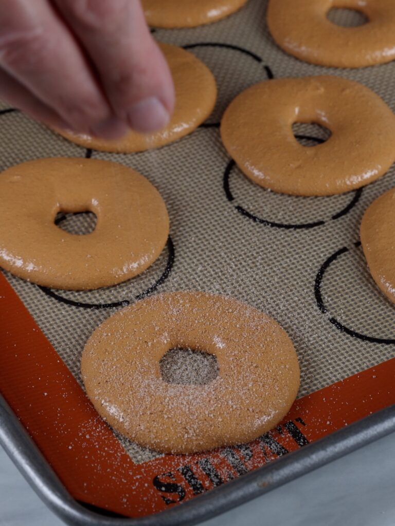 Dusting macarons with the sugar. 