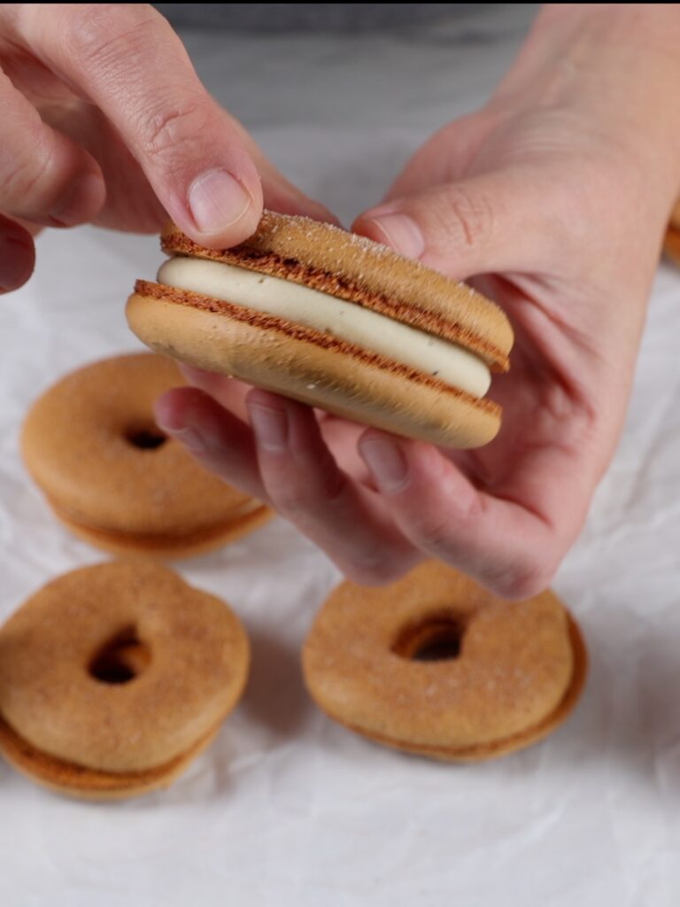 Assembling donut macarons. 