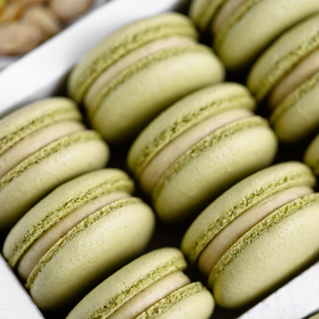 Pistachio Cheesecake Macarons in the box.