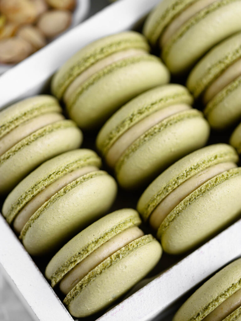 Pistachio Cheesecake Macarons in the box. 