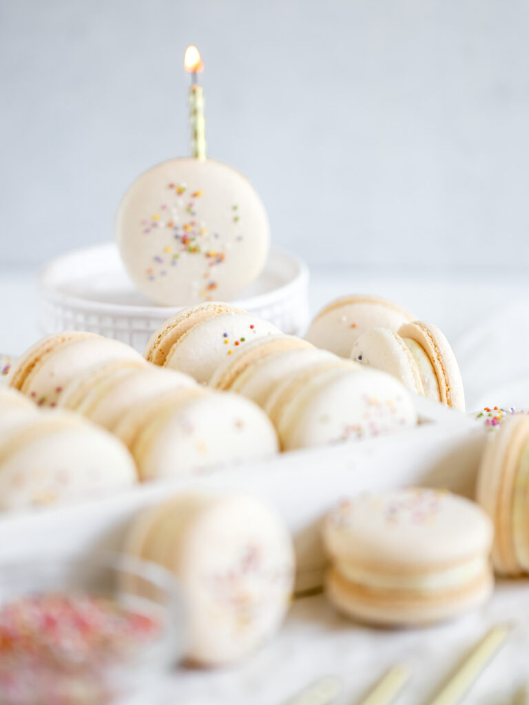 Birthday cake macaron with the candle on the table.