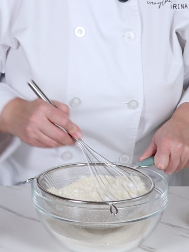 Sifting dry ingredients in the mixing bowl. 