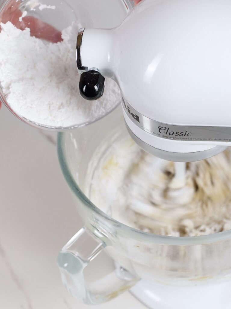 Add powdered sugar to the mixing bowl. 