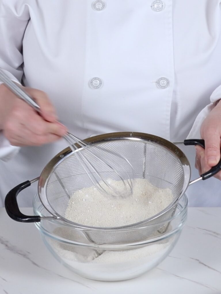 Sifting dry ingredients in the mixing bowl. 