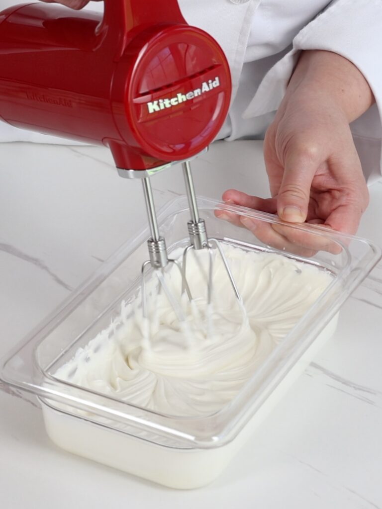 Whipping ganache with a hand mixer. 