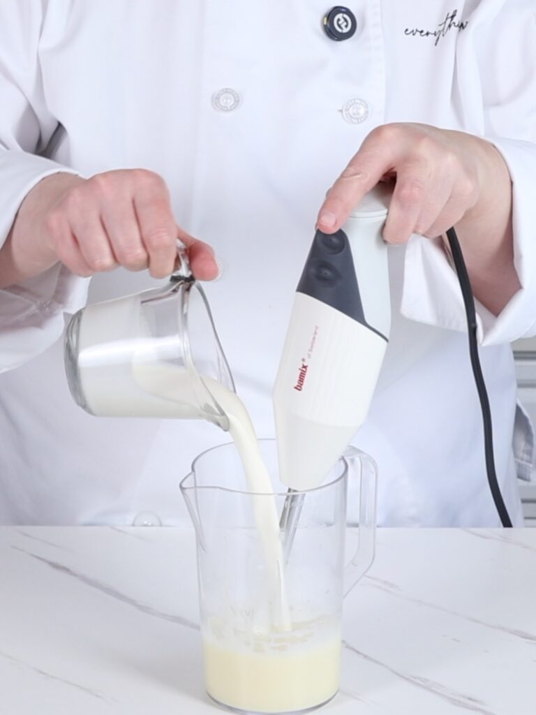 Tall cup with immersion blender. 