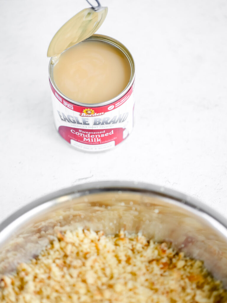 Cake sponge in the bowl and condensed milk. 