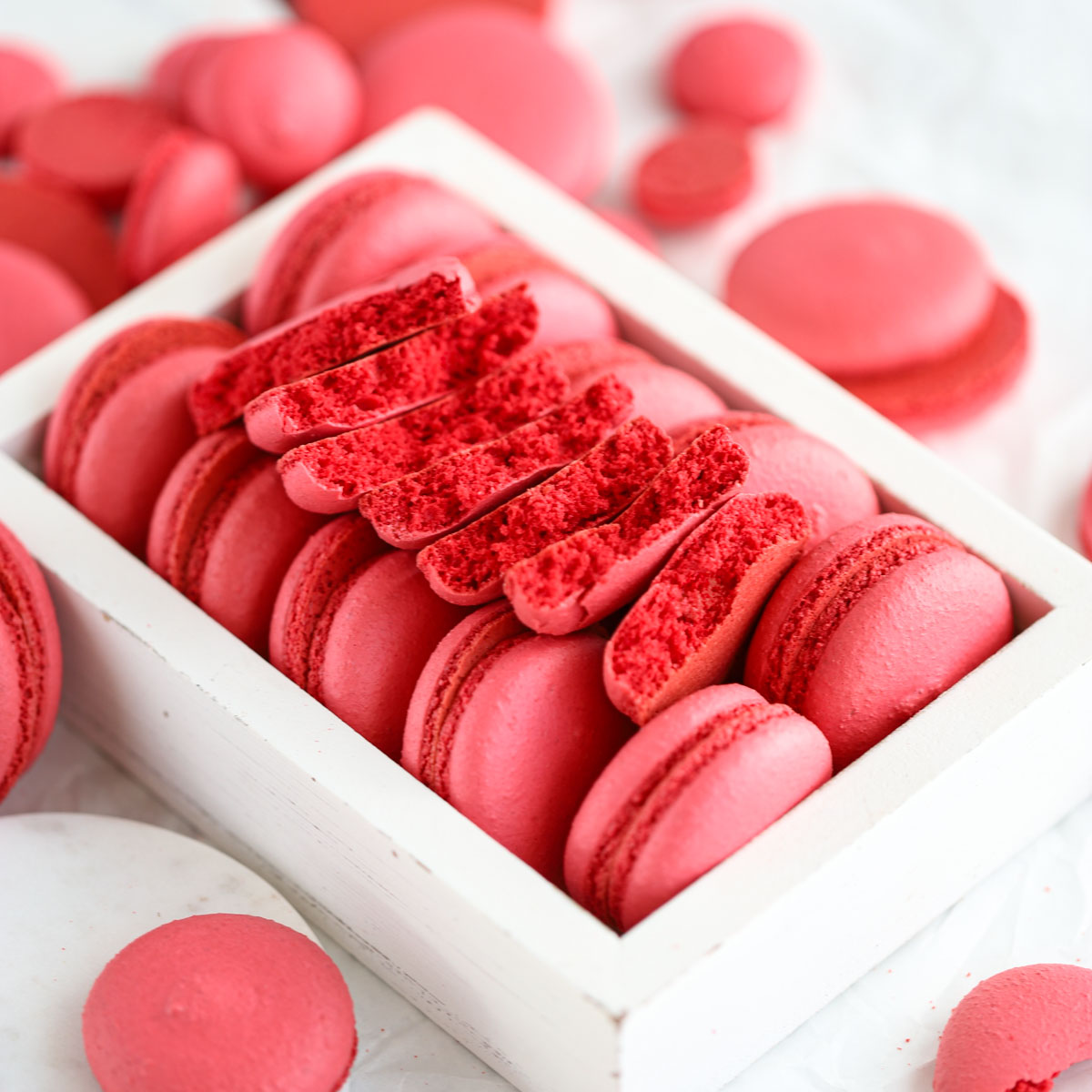 Broken macaron shells on the table.