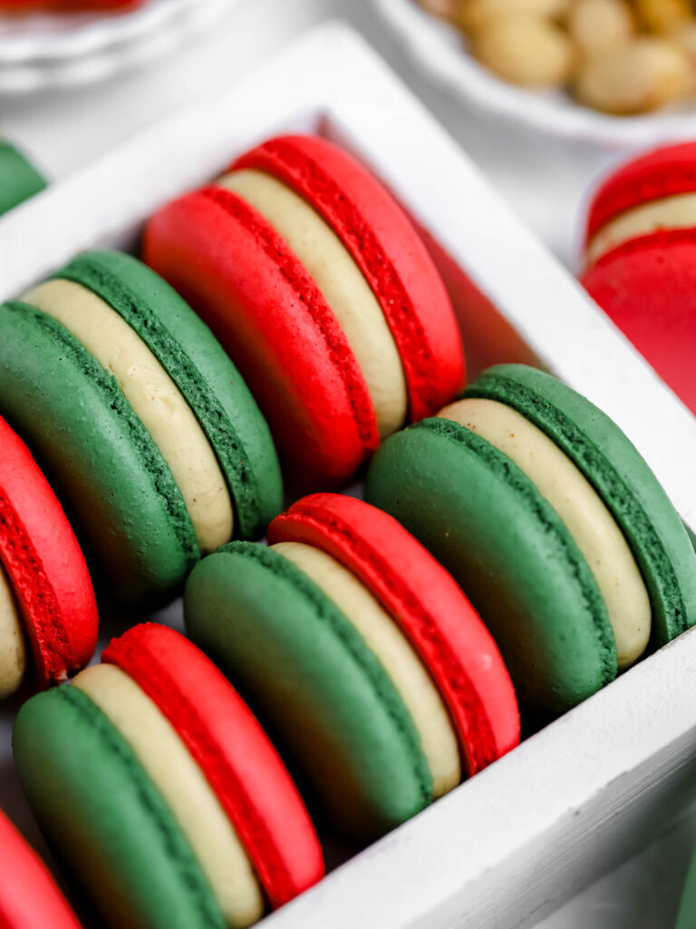 Red and green macarons in the box. 