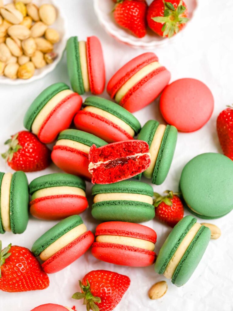 Pistachio Strawberry macarons on the table. 
