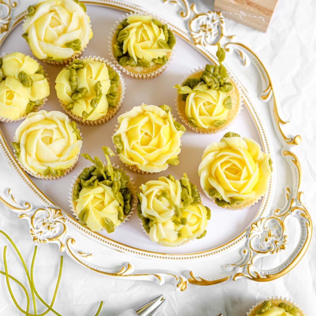 Lemon cupcakes decorated with buttercream flowers.
