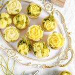 Lemon cupcakes decorated with buttercream flowers.