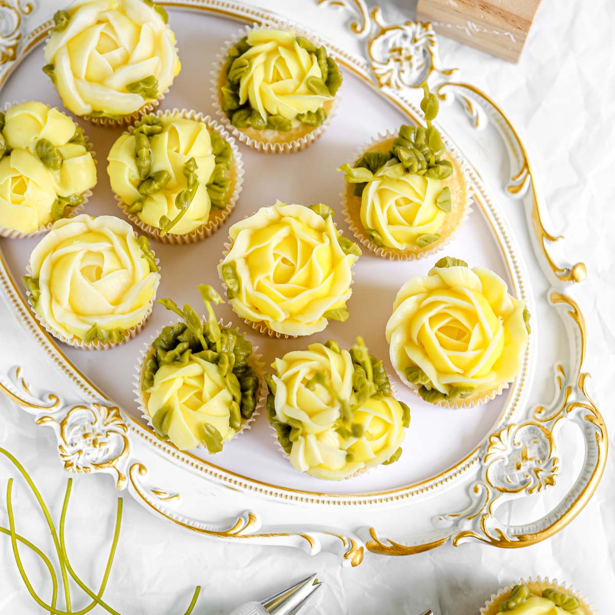Lemon cupcakes decorated with buttercream flowers.