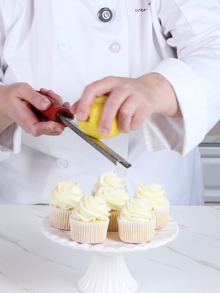 Adding lemon zest to the lemon cupcakes. 