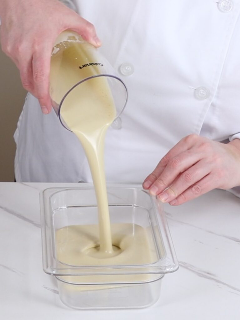 Transferring ganache into a flat container. 
