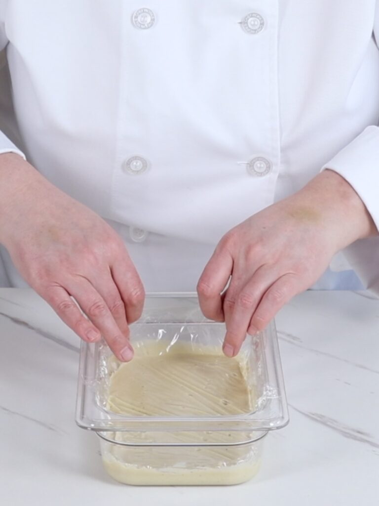 Covering ganache with the plastic wrap. 