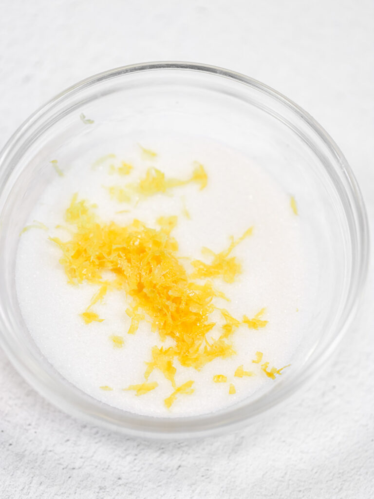 Sugar and lemon zest in the bowl. 