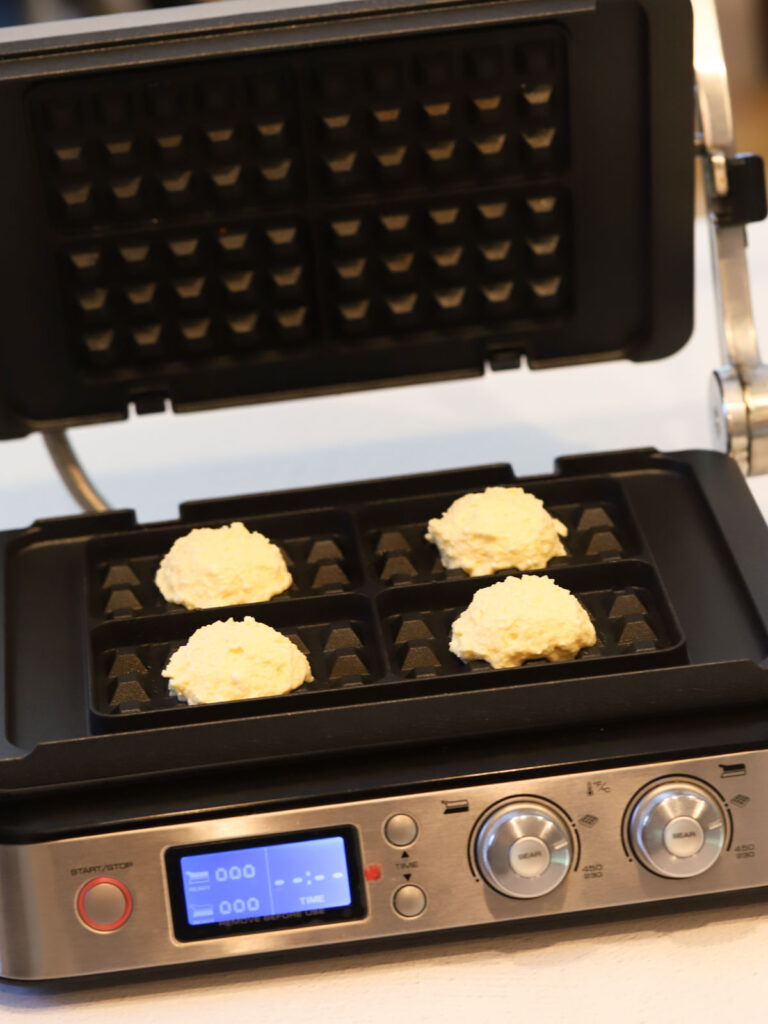 Waffle batter in the waffle maker. 