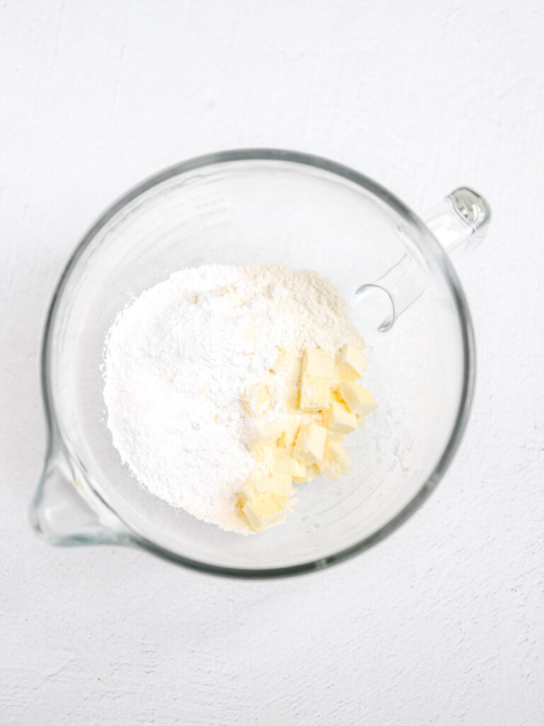 Dry ingredients and the butter in the mixing bowl. 