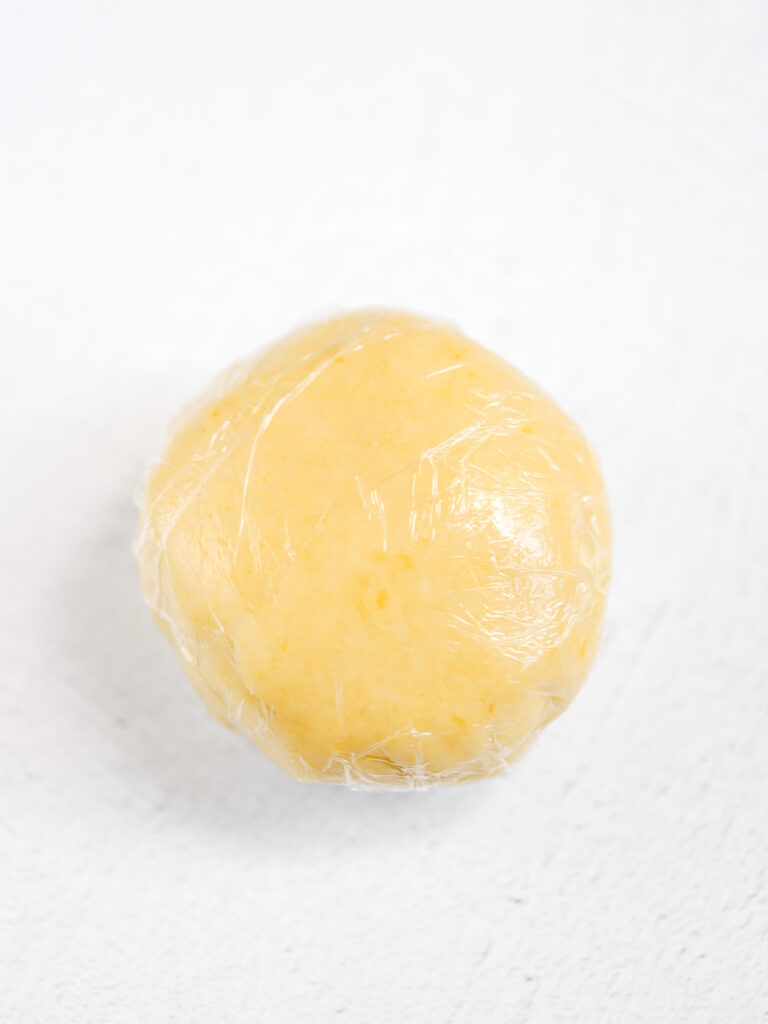 Galette dough wrapped in plastic wrap. 
