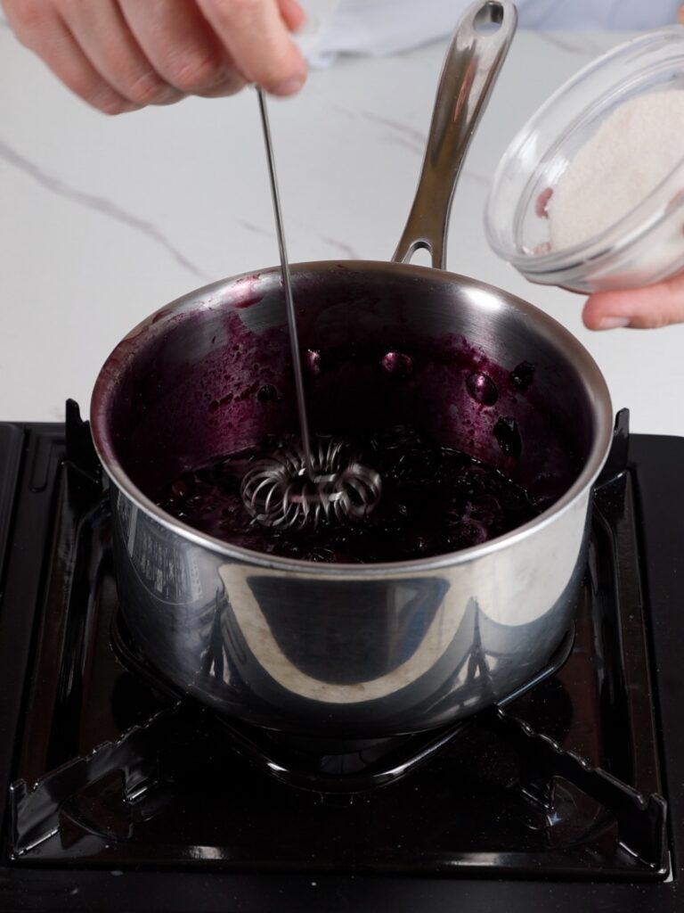 Saucepan with cooked blueberries. 