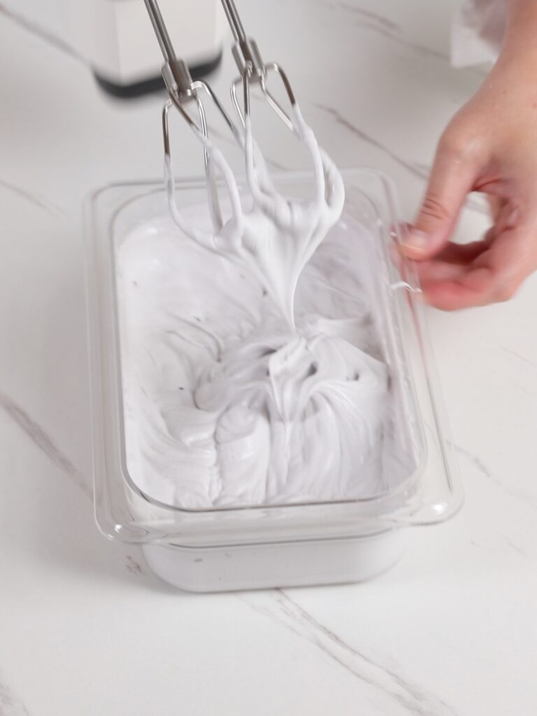 Whipping ganache with a hand mixer. 