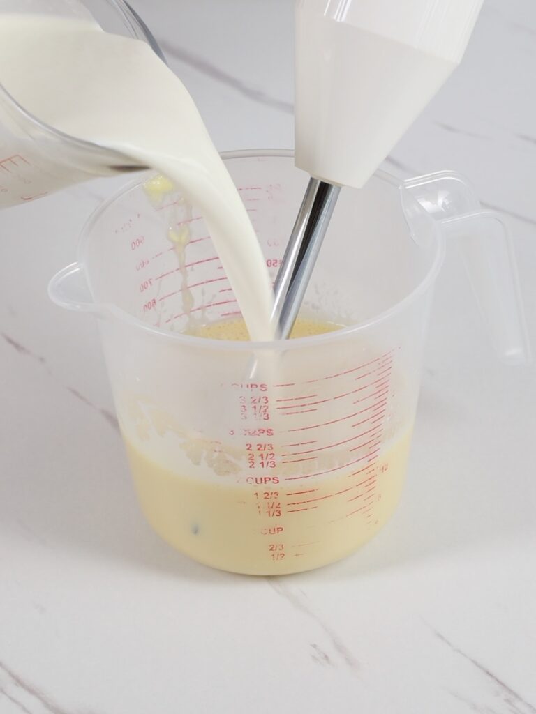 Adding heavy cream to ganache.