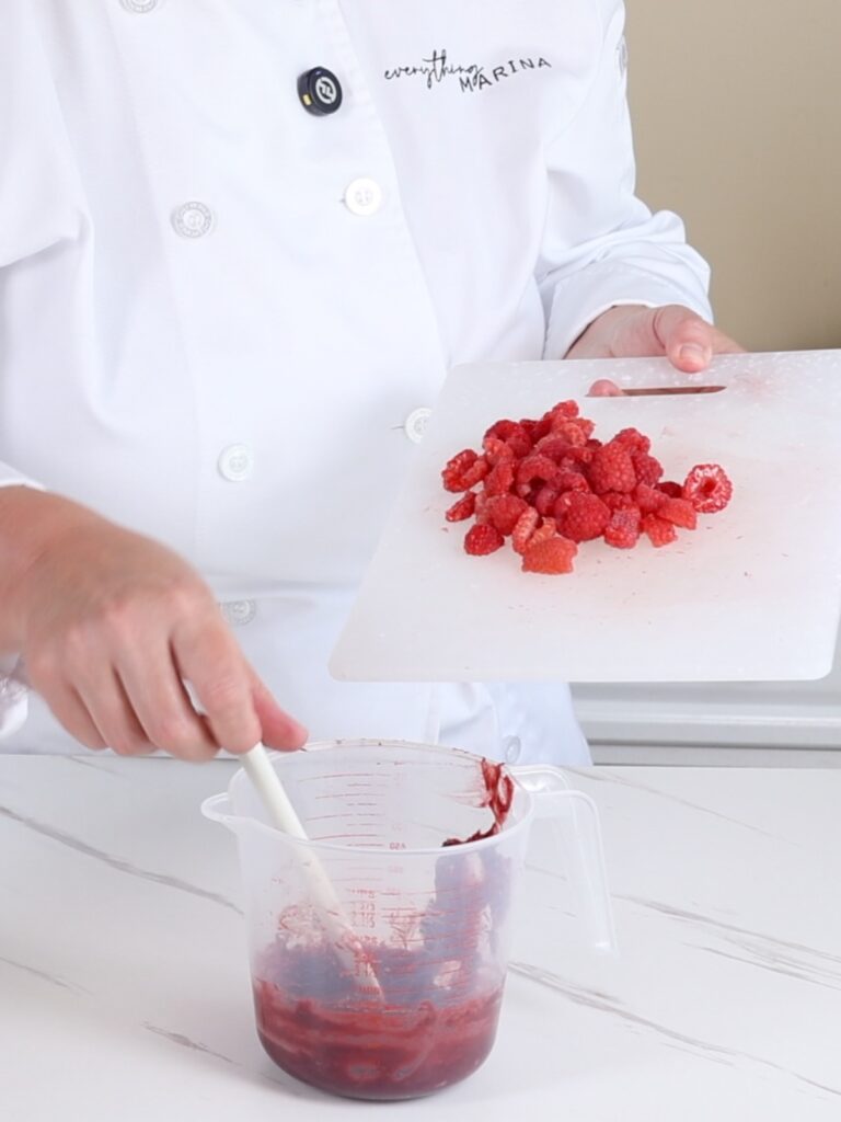 Adding fresh raspberries into confit.