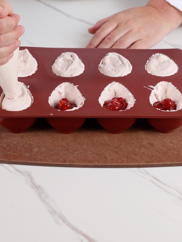 Assembling a viral strawberry dessert.